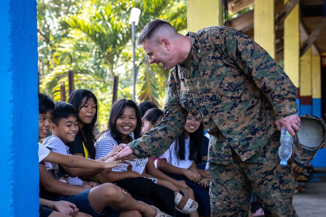 U.S. Marine Corps Col. David J. Fennell, Commander of the Combined Joint Civil-Military Operations Task Force, engages with Alannay Elementary School teachers and students during a school engagement in support of Balikatan 24 at Alannay Elementary School in Lasam, Cagayan, Philippines, April 26, 2024.BK 24 is an annual exercise between the Armed Forces of the Philippines and the U.S. military designed to strengthen bilateral interoperability, capabilities, trust and cooperation built over decades of shared experiences. (U.S. Marine Corps photo by Cpl. Trent A. Henry)