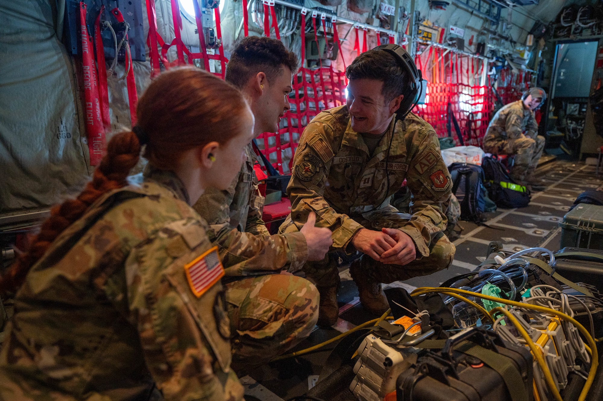 U.S. Air Force Capt. Marc Costello, 86th Aeromedical Evacuation Squadron flight nurse, right, goes over medical equipment with U.S. Army medical team members from the U.S. Army Garrison Rheinland-Pfalz, Baumholder, during an in-flight medical response scenario over Germany, May 7, 2024.