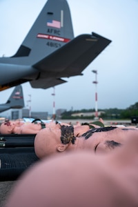 Eleven manikins are lined up outside of a C-130J Super Hercules aircraft, assigned to Kessler Air Force Base, Mississippi, at Ramstein Air Base, Germany, May 7, 2024.