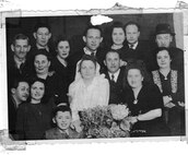 A monochrome photo of Connie Liss' parents (center) at their wedding with extended family. Liss recently spoke to members of the Strategic Systems Programs (SSP) workforce about her mother, Dina Rosenberg Jacobson, and Jacobson's experiences as a Holocaust survivor who was held for three years at Auschwitz. Her presentation was part of SSP's Special Emphasis Programs, which are employee-engagement programs that illuminate underrepresented groups and topics in an effort to highlight diversity within the workforce.
