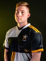 Man with polo standing in front of a black background