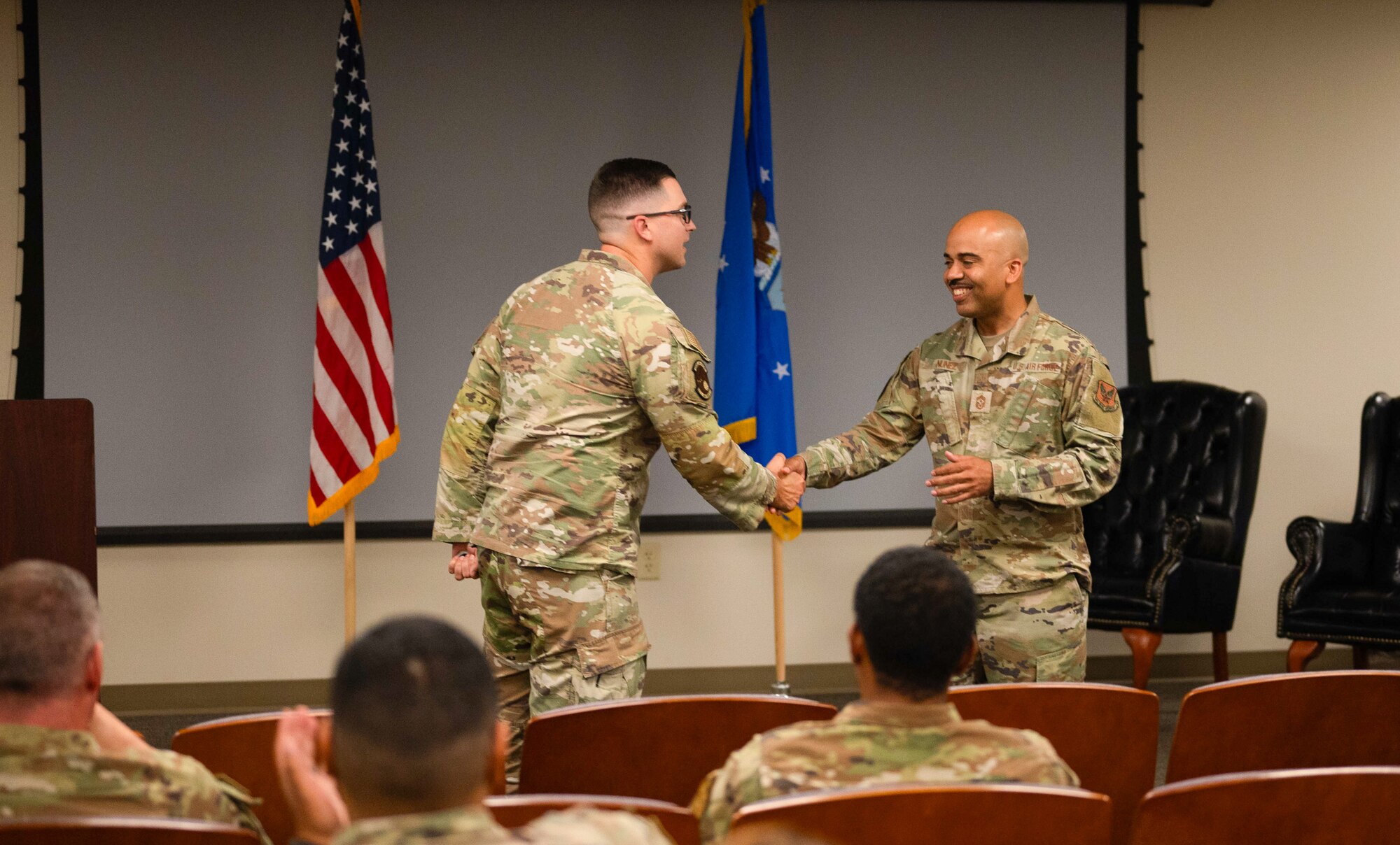 Chief Master Sgt. Israel Nuñez, Senior Enlisted Advisor to the Chief of Air Force Reserve and Command Chief Master Sgt. of Air Force Reserve Command presents a coin to Tech. Sgt. Ryan Strittmatter, 927th Maintenance Squadron, on MacDill Air Force Base, Florida, May 4, 2024 in recognition of top performance. Nuñez visited the 927th Air Refueling Wing Airmen during the unit training assembly and focused on addressing concerns and taking feedback. (U.S. Air Force photo by Staff Sgt. Alexis Suarez)