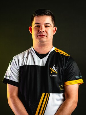 Man with a multi-color polo standing in front of a black background.