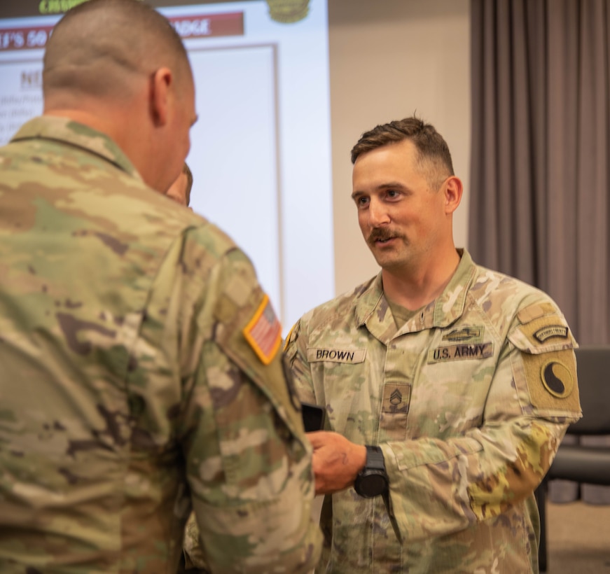 U.S. Army Staff Sgt. Adam Brown receives the Chief's 50 badge for marksmanship excellence during the Winston P. Wilson Championship hosted by the National Guard Marksmanship Training Center in Camp Robinson, Arkansas, from April 27-May 3, 2024. The WPW competition showcases the adaptiveness, resilience, and lethality of our forces, affirming the readiness of National Guard citizen-Soldiers to meet the nation’s challenges. (U.S. Army National Guard photo by Sgt. Destini Keene)