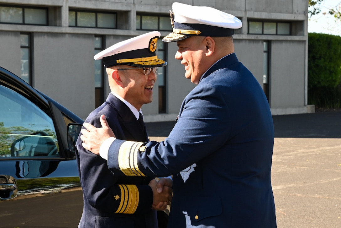 U.S. Coast Guard Vice Adm. Andrew Tiongson, commander, U.S. Coast Guard Pacific Area, (right) greets Japan coast guard Vice Adm. Watanabe Yasunori, Japan coast guard vice commandant for operations, on Coast Guard Island, Alameda, Calif., May 9, 2024. Watanabe visited Coast Guard Pacific Area to finalize a trilateral letter of intent between U.S. Coast Guard, Japan and Korea coast guards, which will drive the three nations’ coast guards to work together to advance maritime safety, security and prosperity in the Indo-Pacific. (U.S. Coast Guard photo by Master Chief Petty Officer Charly Tautfest)