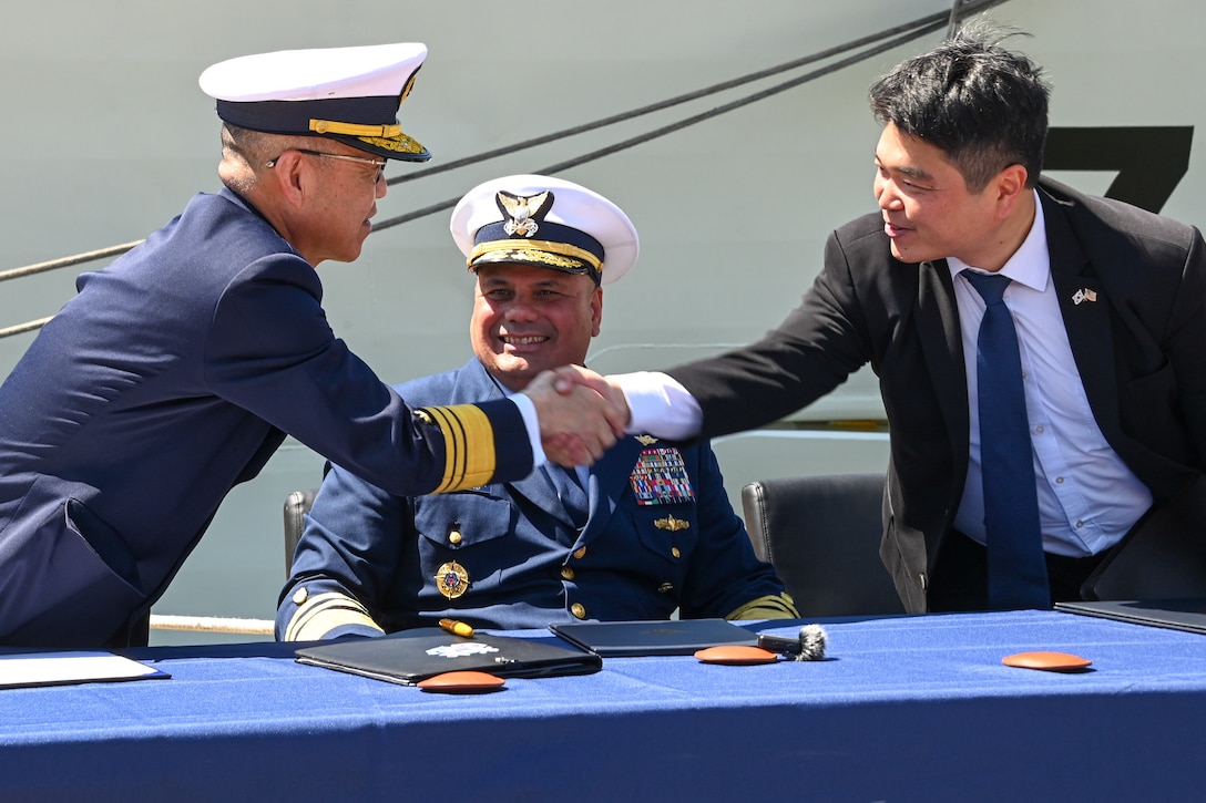 Japan coast guard Vice Adm. Watanabe Yasunori, Japan coast guard vice commandant for operations, (left) shakes hands with Hyunchul Kang, deputy Consul General of the Republic of Korea, as U.S. Coast Guard Vice Adm. Andrew Tiongson, commander, U.S. Coast Guard Pacific Area, looks on, on Coast Guard Island, Alameda, Calif., May 9, 2024. Watanabe visited Coast Guard Pacific Area to finalize a trilateral letter of intent between U.S. Coast Guard, Japan and Korea coast guards, which will drive the three nations’ coast guards to work together to advance maritime safety, security and prosperity in the Indo-Pacific. (U.S. Coast Guard photo by Master Chief Petty Officer Charly Tautfest)