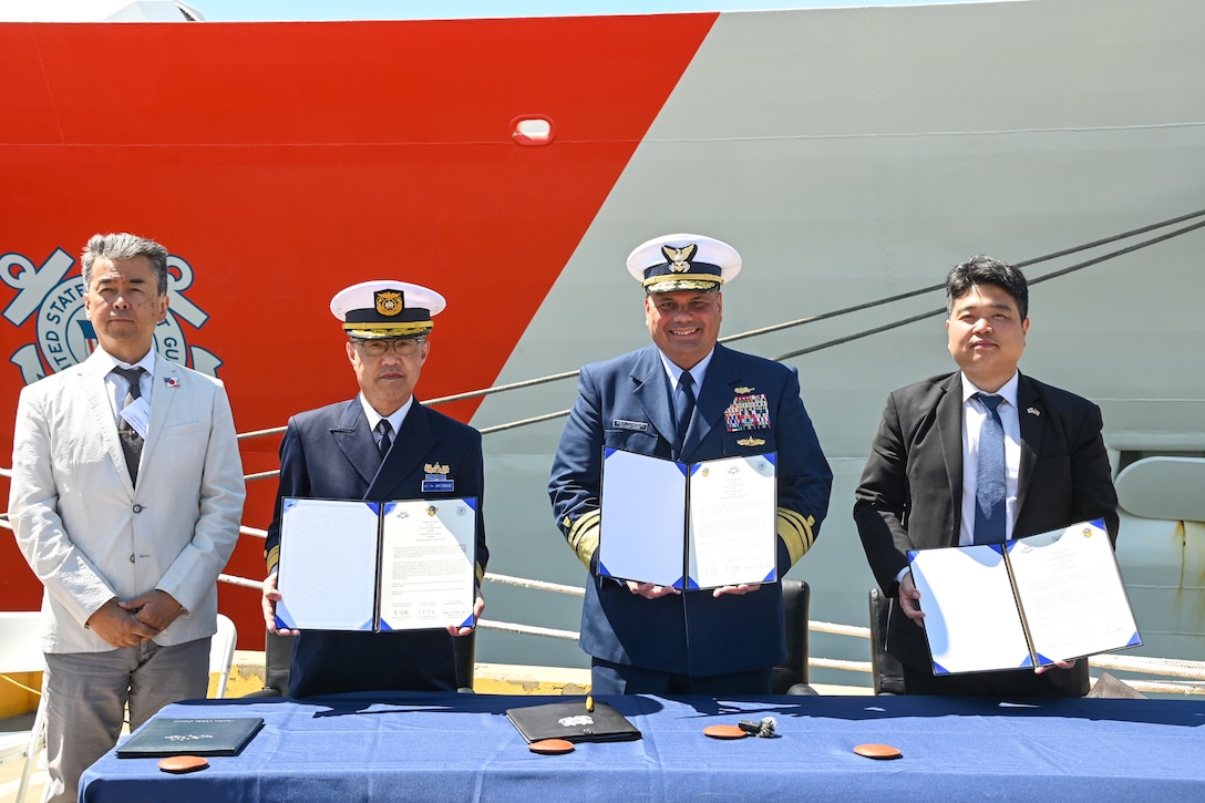 Mr. Kishimori Hajime, deputy Consul General of Japan (left), Japan coast guard Vice Adm. Watanabe Yasunori, Japan coast guard vice commandant for operations, U.S. Coast Guard Vice Adm. Andrew Tiongson, commander, U.S. Coast Guard Pacific Area, and Hyunchul Kang, deputy Consul General of the Republic of Korea, pose with a signed trilateral agreement at Coast Guard Island, Alameda, Calif., May 9, 2024. Japan, Republic of Korea and U.S. coast guards gathered to finalize a trilateral letter of intent, which will drive the three nations to work together to advance maritime safety, security and prosperity in the Indo-Pacific. (U.S. Coast Guard photo by Master Chief Petty Officer Charly Tautfest)