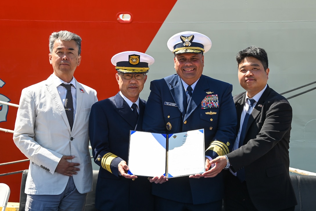 Mr. Kishimori Hajime, deputy Consul General of Japan (left), Japan coast guard Vice Adm. Watanabe Yasunori, Japan coast guard vice commandant for operations, U.S. Coast Guard Vice Adm. Andrew Tiongson, commander, U.S. Coast Guard Pacific Area, and Hyunchul Kang, deputy Consul General of the Republic of Korea, pose with a signed trilateral agreement at Coast Guard Island, Alameda, Calif., May 9, 2024. Japan, Republic of Korea and U.S. coast guards gathered to finalize a trilateral letter of intent between the three nations, which will drive the countries together to work together to advance maritime safety, security and prosperity in the Indo-Pacific. (U.S. Coast Guard photo by Master Chief Petty Officer Charly Tautfest)