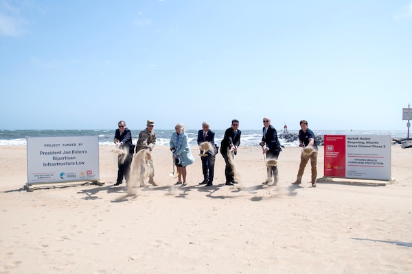 With gold-painted shovels in hand, seven stakeholders dig up sand to represent breaking ground. The ceremonial groundbreaking marks the commencement of construction for the final Norfolk Harbor Deepening contract along with the upcoming beach nourishment projects at Resort and Croatan beaches.