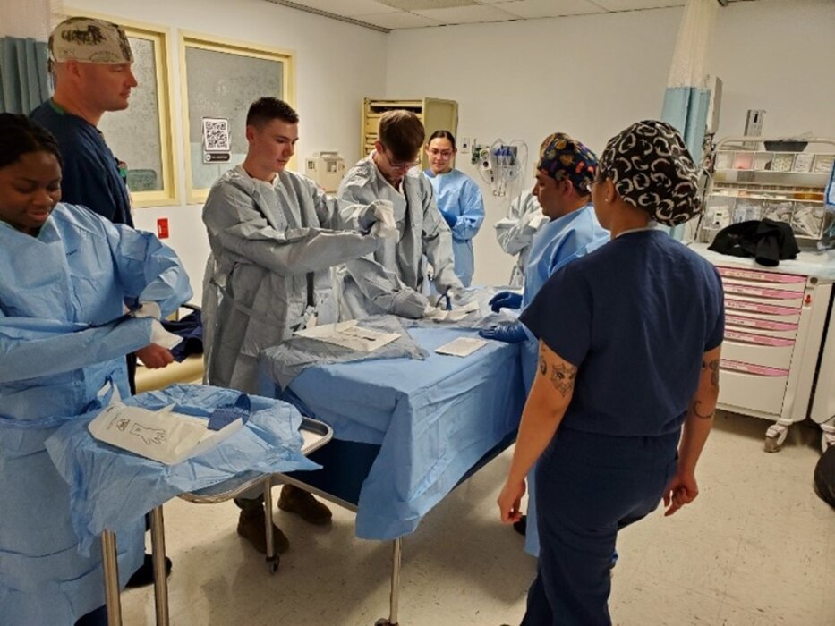 ROTA, Spain- Petty Officer 2nd Class Gerardo Mojica-Garcia, a Surgical Technician, facilitates intraoperative teaching addressing the importance of sterility and preparation during procedures. Participants donned sterile gowns and gloves to focus on aseptic practices that can prevent contamination and prevent surgical site infections. This training is a part of Navy Medicine Readiness and Training Command’s (NMRTC) Rota quarterly readiness training program focused on enhancing clinical readiness skills, at times outside of their specialization, to better prepare them for various situations in both traditional and operational settings. (Photo by Lt. Cmdr. Jason Kopp / Released by Cmdr. Jenny Paul)