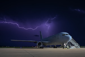 A KC-46 Pegasus aircraft sits on the flightline during a storm