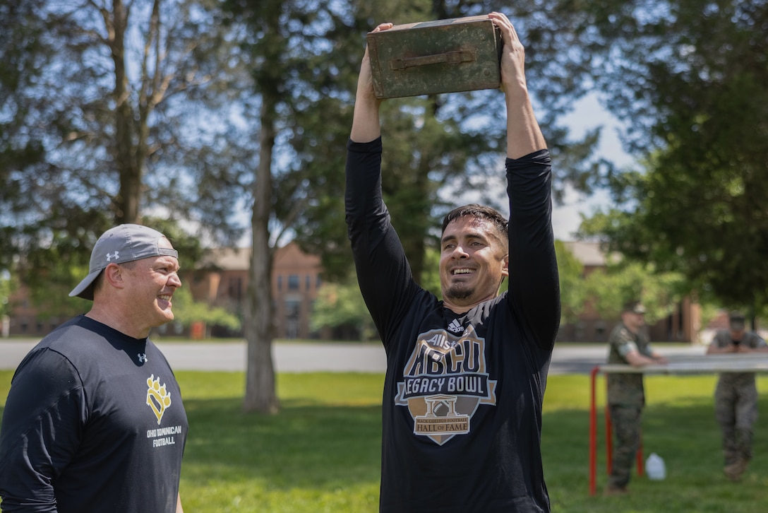 Kelly Cummings, head football coach at Ohio Dominican University, left, counts the number of repetitions that Quinn Brown, offensive line coach and run game coordinator at Bowie State University, conducts the ammunition-can lift portion of the Marine Corps Combat Fitness Test during the Coaches Workshop, hosted by Marine Corps Recruiting Command on Marine Corps Base Quantico, Va., May 8, 2024. The Coaches Workshop provided attendees from across the country the opportunity to see how Marines are recruited, trained, and developed into leaders. Upon completion of the workshop, attending coaches and educators returned to their schools and community equipped with a better understanding of the Marine Corps and ability to tell the Marine Corps story. (U.S. Marine Corps photo by Lance Cpl. Brenna Ritchie)