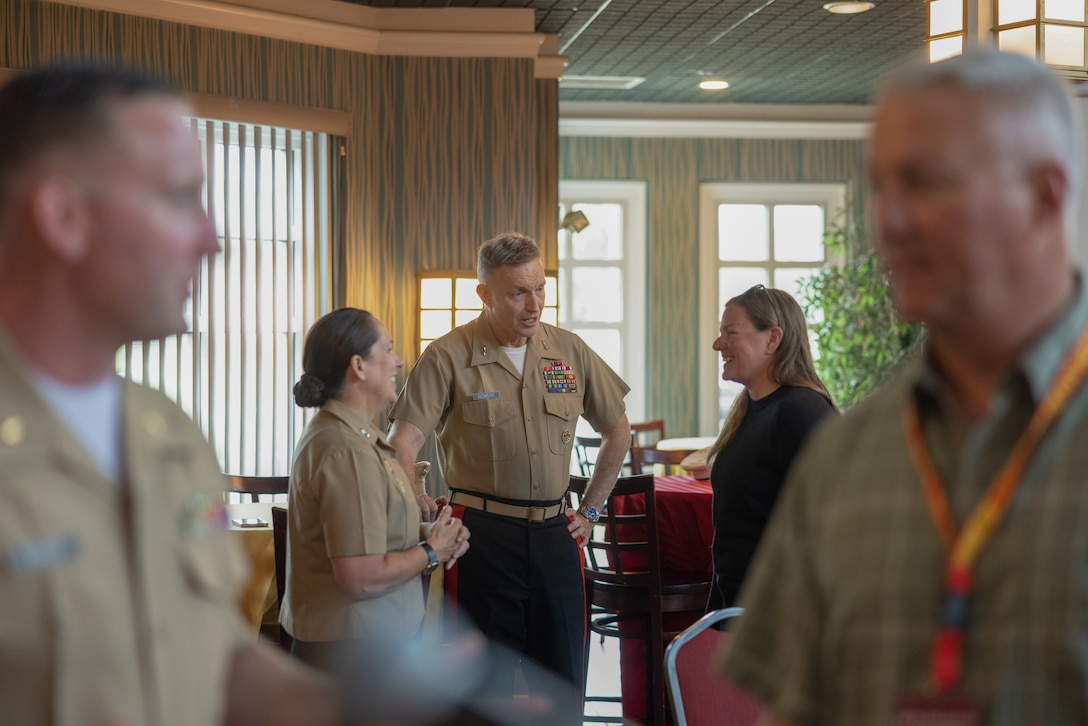 U.S. Marine Corps Maj. Gen. Roberta Shea, legislative assistant to the Commandant of the Marine Corps, left, and Maj. Gen. William Bowers, commanding general, Marine Corps Recruiting Command, center, speak to Kim Chavers, head women’s rowing coach at Nova Southeastern University at a dinner event during the Coaches Workshop on Marine Corps Base Quantico, Va., May 8, 2024. The Coaches Workshop, from May 6 - 10, gave college coaches and educators from across the country the opportunity to see how Marines are recruited, trained, and developed into leaders. Upon completion of the workshop, attending coaches and educators returned to their schools and community equipped with a better understanding of the Marine Corps and ability to tell the Marine Corps story. (U.S. Marine Corps photo by Lance Cpl. Brenna Ritchie)