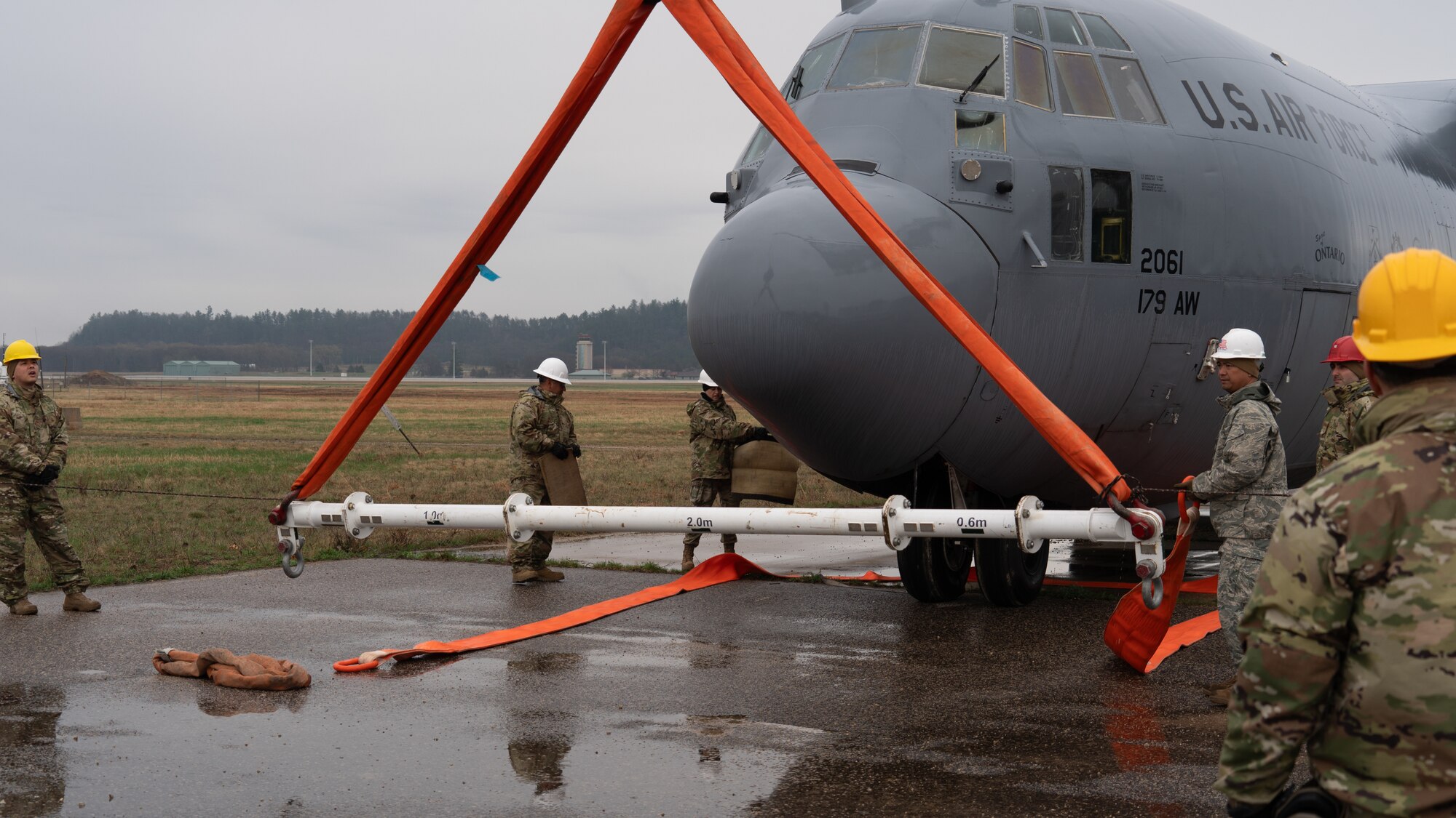 U.S. Air Force Airmen assigned to the 146th Maintenance Group part of the 146th Airlift Wing based on Channel Islands Air National Guard Station (CIANGS), practice executing the fundamentals of Crash Damaged and Disabled Aircraft Recovery (CDDAR) on Volk Field in Camp Douglas, Wisconsin April 16-18, 2024. The CDDAR certified members and augmentees used airbags, forklifts and cranes to raise, pull and stabilize aircraft that simulated different scenarios of downed airplanes. (U.S. Air National Guard photo by Staff Sgt. Kalia Jenkins)