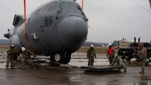 U.S. Air Force Airmen assigned to the 146th Maintenance Group part of the 146th Airlift Wing based on Channel Islands Air National Guard Station (CIANGS), practice executing the fundamentals of Crash Damaged and Disabled Aircraft Recovery (CDDAR) on Volk Field in Camp Douglas, Wisconsin April 16-18, 2024. The CDDAR certified members and augmentees used airbags, forklifts and cranes to raise, pull and stabilize aircraft that simulated different scenarios of downed airplanes. (U.S. Air National Guard photo by Staff Sgt. Kalia Jenkins)