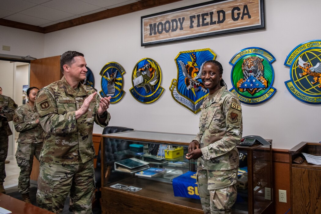 U.S. Air Force Senior Airman Coumba Diouf, 23rd Security Forces Squadron patrolman, right, poses for a photo after being recognized by Maj. Gen. David Lyons, Fifteenth Air Force commander, during a base tour at Moody Air Force Base, Georgia, May 2, 2024. During his visit, Lyons got a chance to meet with Airmen who enable Airpower every day, and learn about what they do to ensure the Flying Tigers can project agile airpower across the globe. (U.S. Air Force Photo by Senior Airman Courtney Sebastianelli)