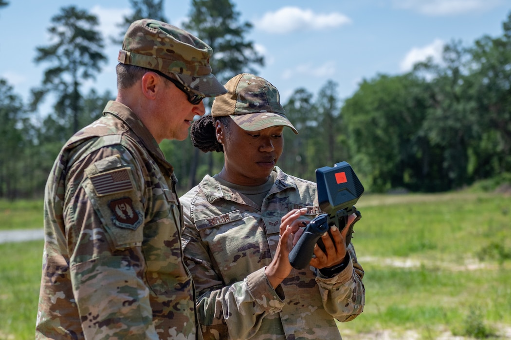 U.S. Air Force Senior Airman Gabrielle Taylor, 822nd Base Defense Squadron squad systems operator, right, briefs Maj. Gen. David Lyons, Fifteenth Air Force commander, during a base tour at Moody Air Force Base, Georgia, May 3, 2024. During his visit, Lyons got a chance to meet with Airmen who enable Airpower every day, and learn about what they do to ensure the Flying Tigers can project agile airpower across the globe. (U.S. Air Force Photo by Senior Airman Courtney Sebastianelli)