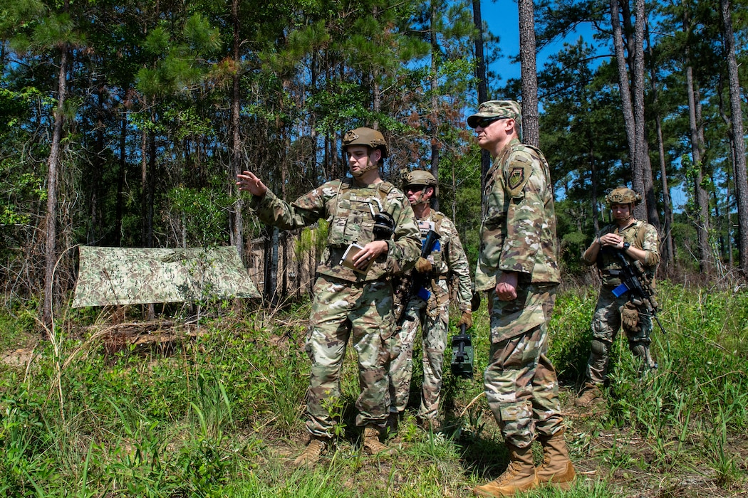 A U.S. Air Force Airmen assigned to the 820th Base Defense Group briefs Maj. Gen. David Lyons, Fifteenth Air Force commander, during a field training at Moody Air Force Base, Georgia, May 3, 2024. BDG units master tactical battlefield leadership and battle staff specialties to effectively integrate partner units into the fight. (U.S. Air Force Photo by Senior Airman Courtney Sebastianelli)