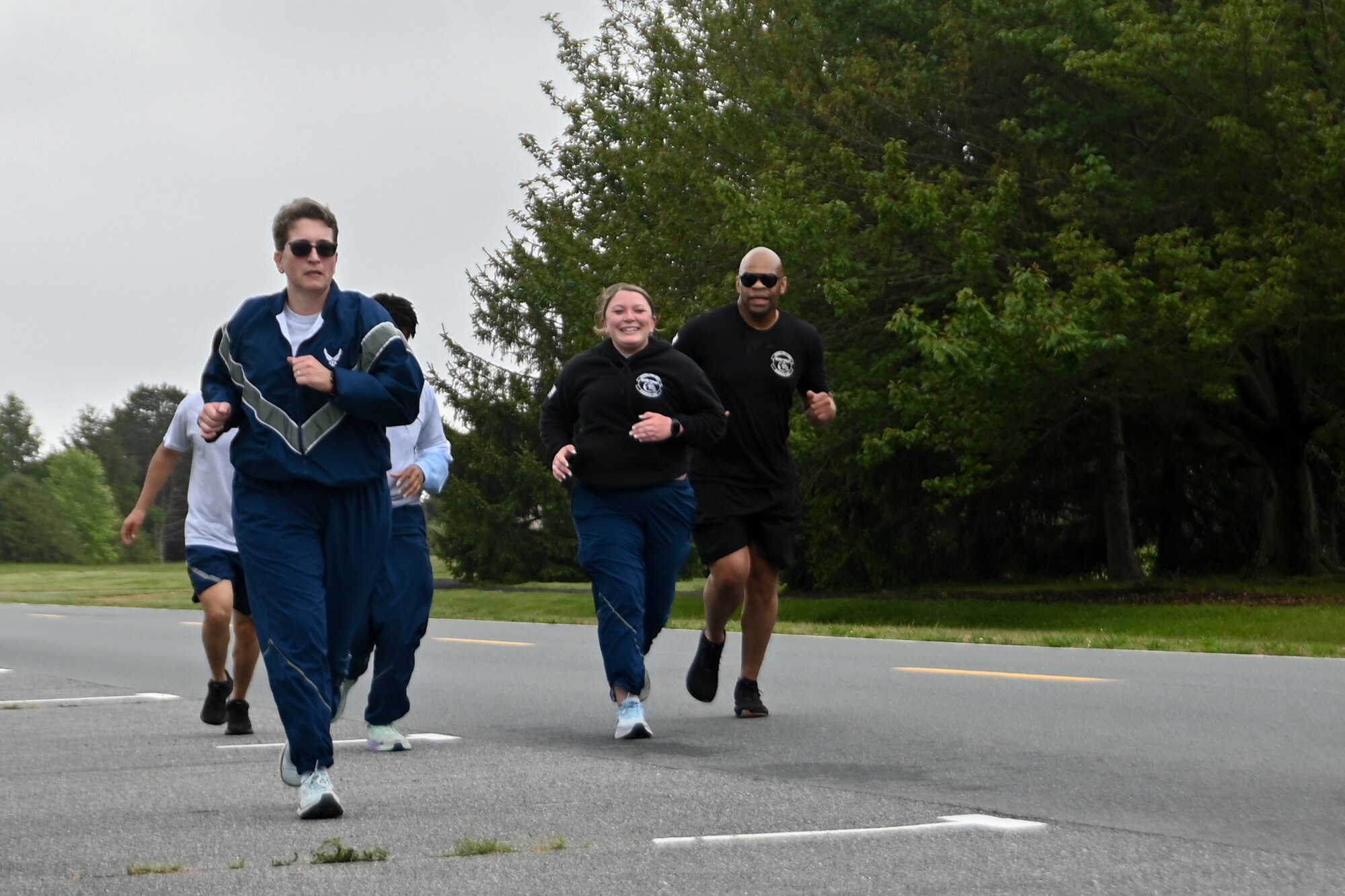 Chief Master Sgt. Travon Dennis, 4th Air Force command chief, March Air Reserve Base, California, runs alongside 46th Aerial Port Squadron reservists during the Port Dawg Memorial Run on Dover Air Force Base, Delaware, May 5, 2024. The memorial run honors fallen U.S. Air Force aerial port members. (U.S. Air Force photo by Staff Sgt. Kalee Sexton)