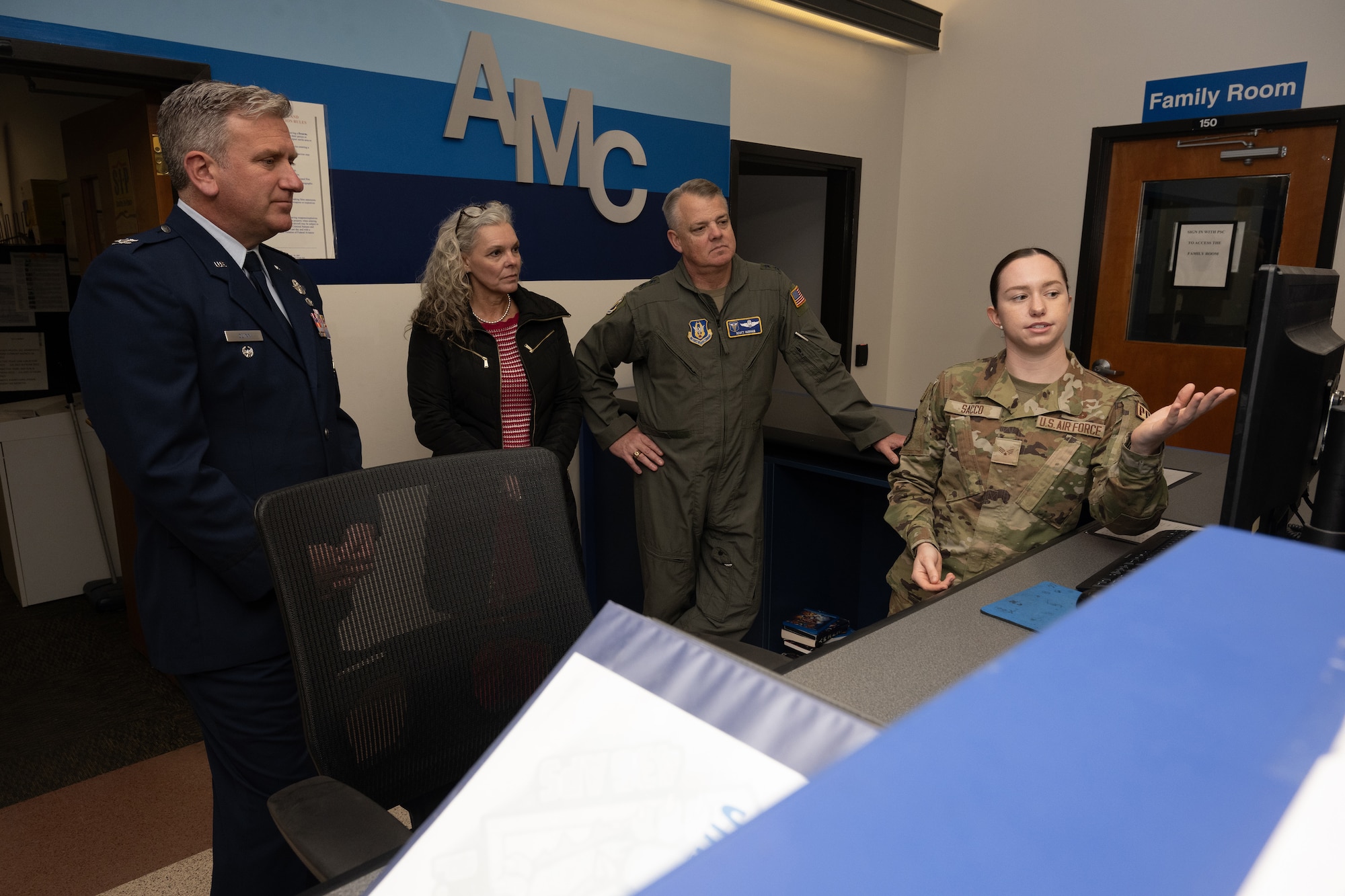Airman 1st Class Amelia Sacco, 46th Aerial Port Squadron passenger services representative, right, demonstrates her responsibilities to Maj. Gen. D. Scott Durham, 4th Air Force commander, Mrs. Jennifer Durham and Col. Brian Quinn, 512th Airlift Wing deputy commander, May 5, 2024, on Dover Air Force Base, Delaware. Sacco was recognized as the 512th AW’s Liberty Wing Warrior for May 2024. (U.S. Air Force Photo by Senior Airman John Rossi)