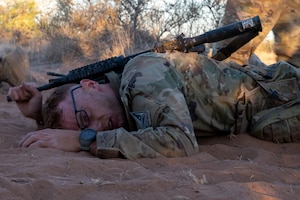 U.S. Space Force Capt. Bradley Evans, White Sands Missile Range developmental engineer, low crawls through the sand during a Spur Ride at Fort Bliss, Texas, April 29, 2024.