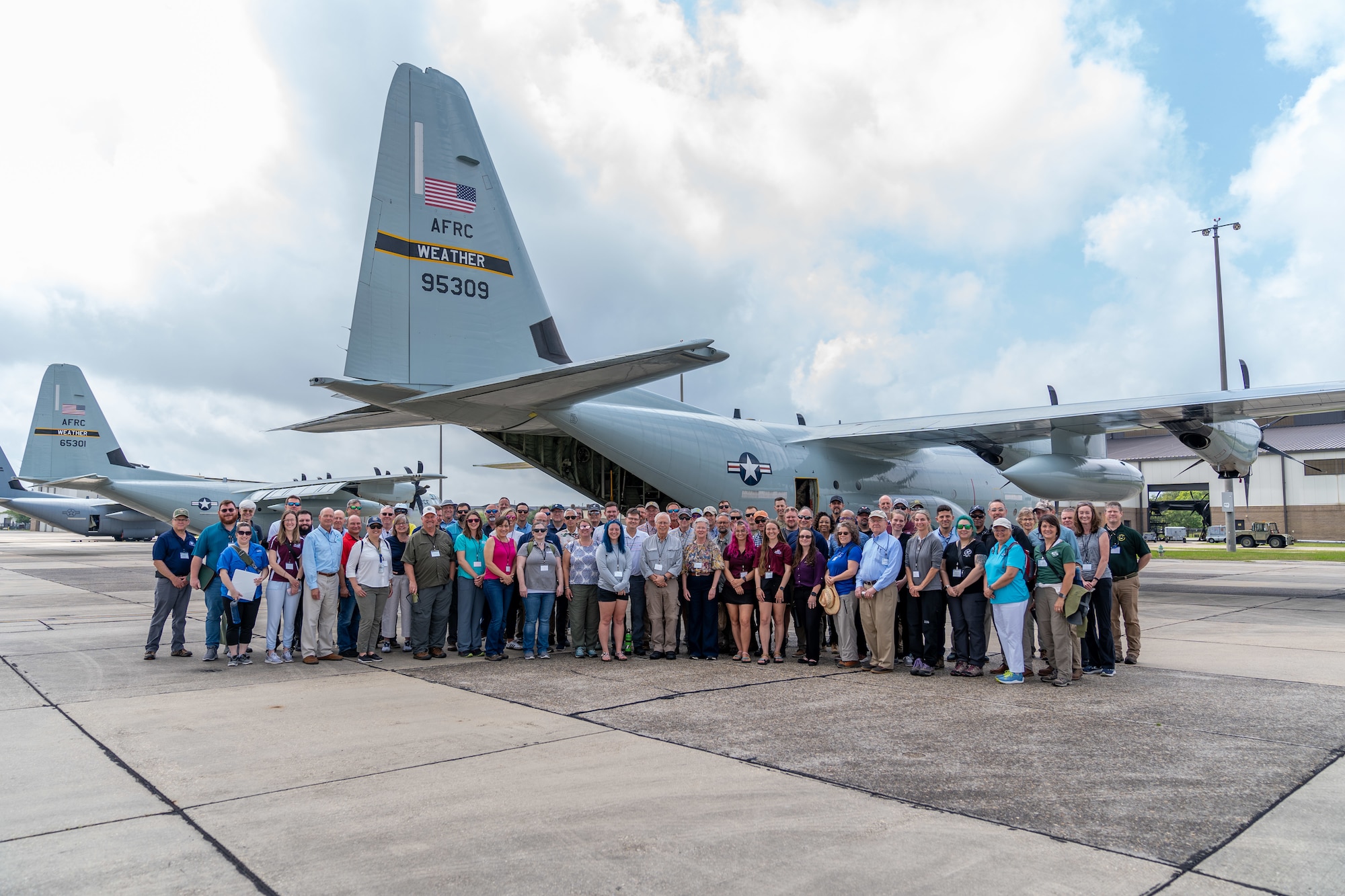 Members of the Southeast Regional Partnership for Planning and Sustainability pose for a group photo in front of a C-130J Hercules from the Hurricane Hunters at Keesler Air Force Base, Mississippi, May 8, 2024. The SERPPAS team met with Keesler leadership to discuss common challenges, climate impacts and community collaboration projects. (U.S. Air Force photo by Andrew Young)