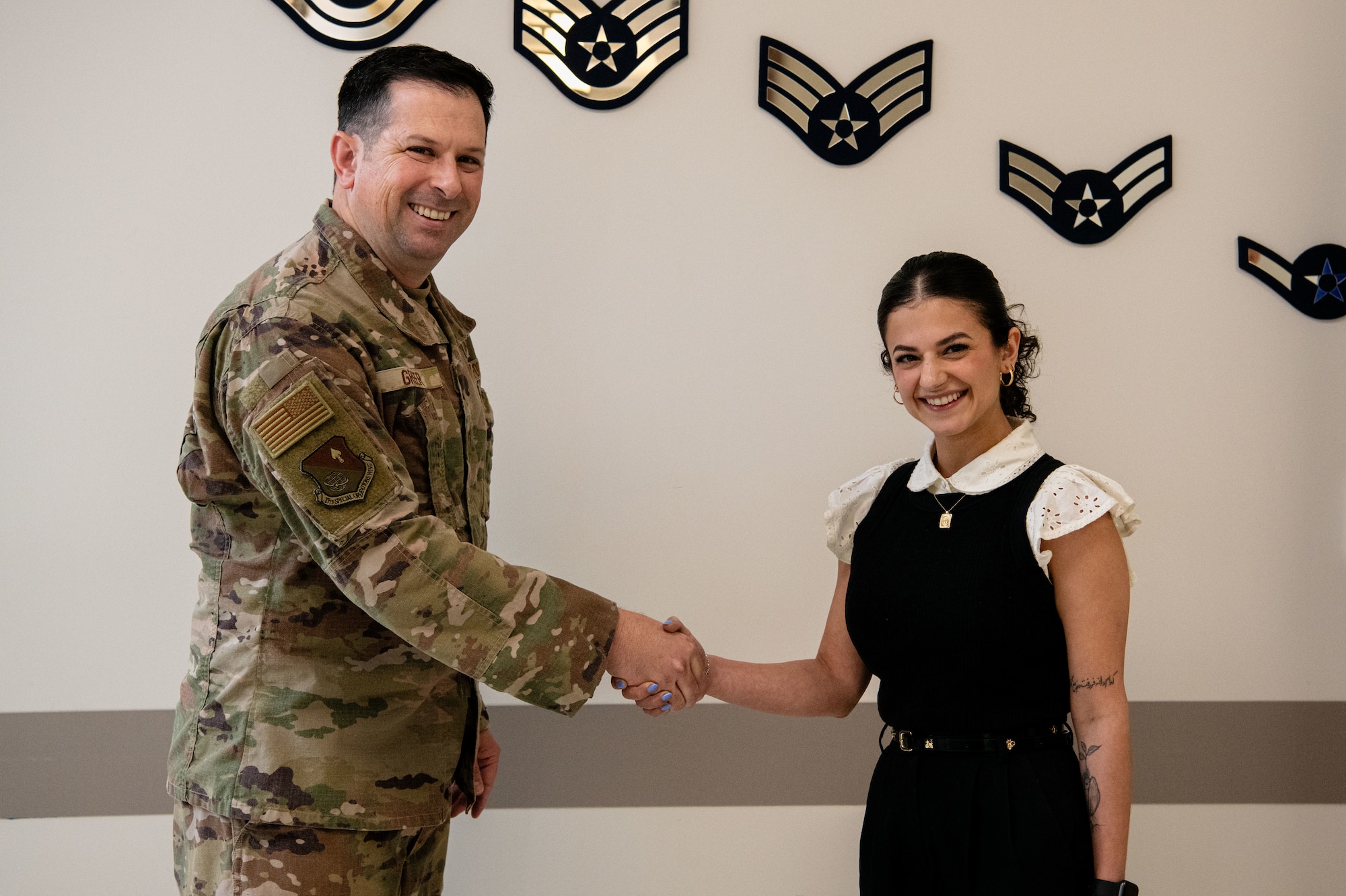 U.S. Air Force Col. Brent Greer, 27th Special Operations Wing deputy commander, coins Dr. Maedeh Bazmi, 27th Special Operations Medical Group director of accreditation, compliance, and risk management, for her outstanding performance and assistance in getting the 27 SOMDG accredited and certified by The Joint Commission at Cannon Air Force Base, New Mexico, May 10, 2024. The 27 SOMDG gained The Gold Seal of Approval ® from the Joint Commission by undergoing a rigorous, unannounced site visit. The Joint Commission is an organization that accredits more than 22,000 U.S. healthcare organizations and programs. (U.S. Air Force photo by Staff Sgt. Vernon R. Walter III)