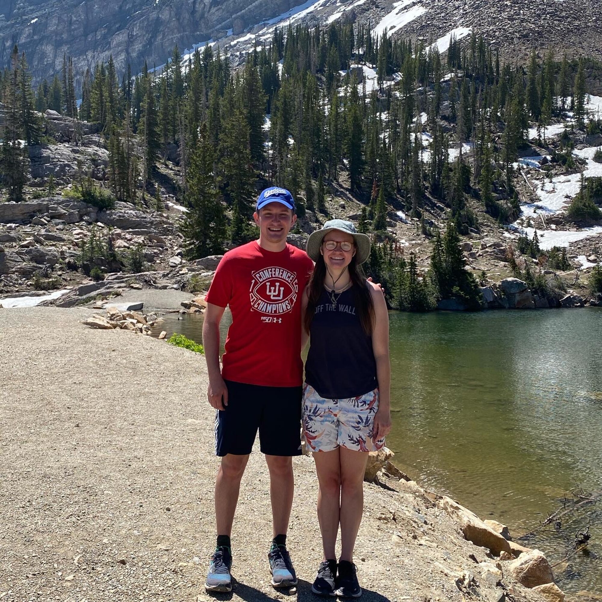 A couple poses for a photo in the mountains