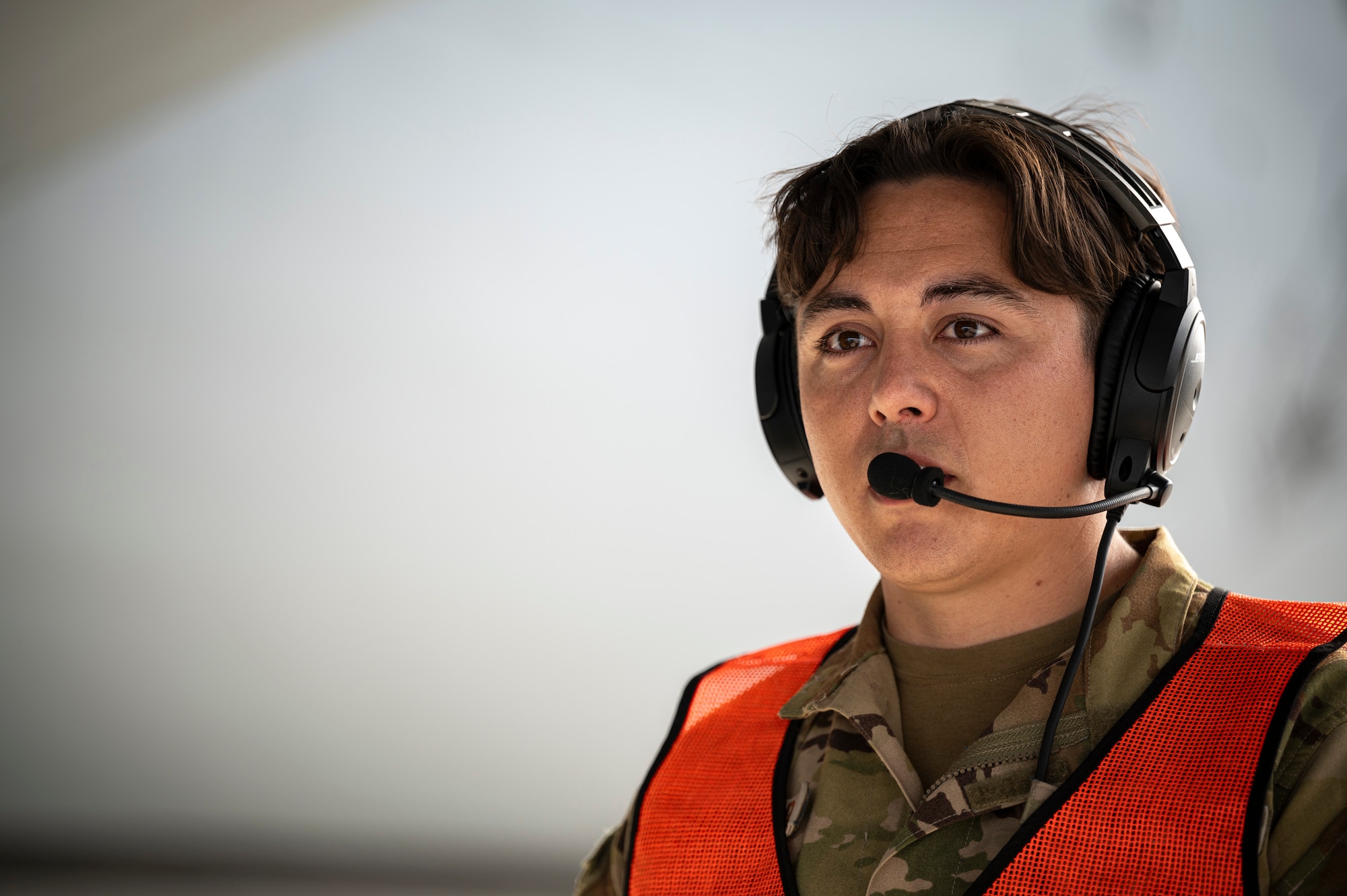 A servicemember communicates via headset
