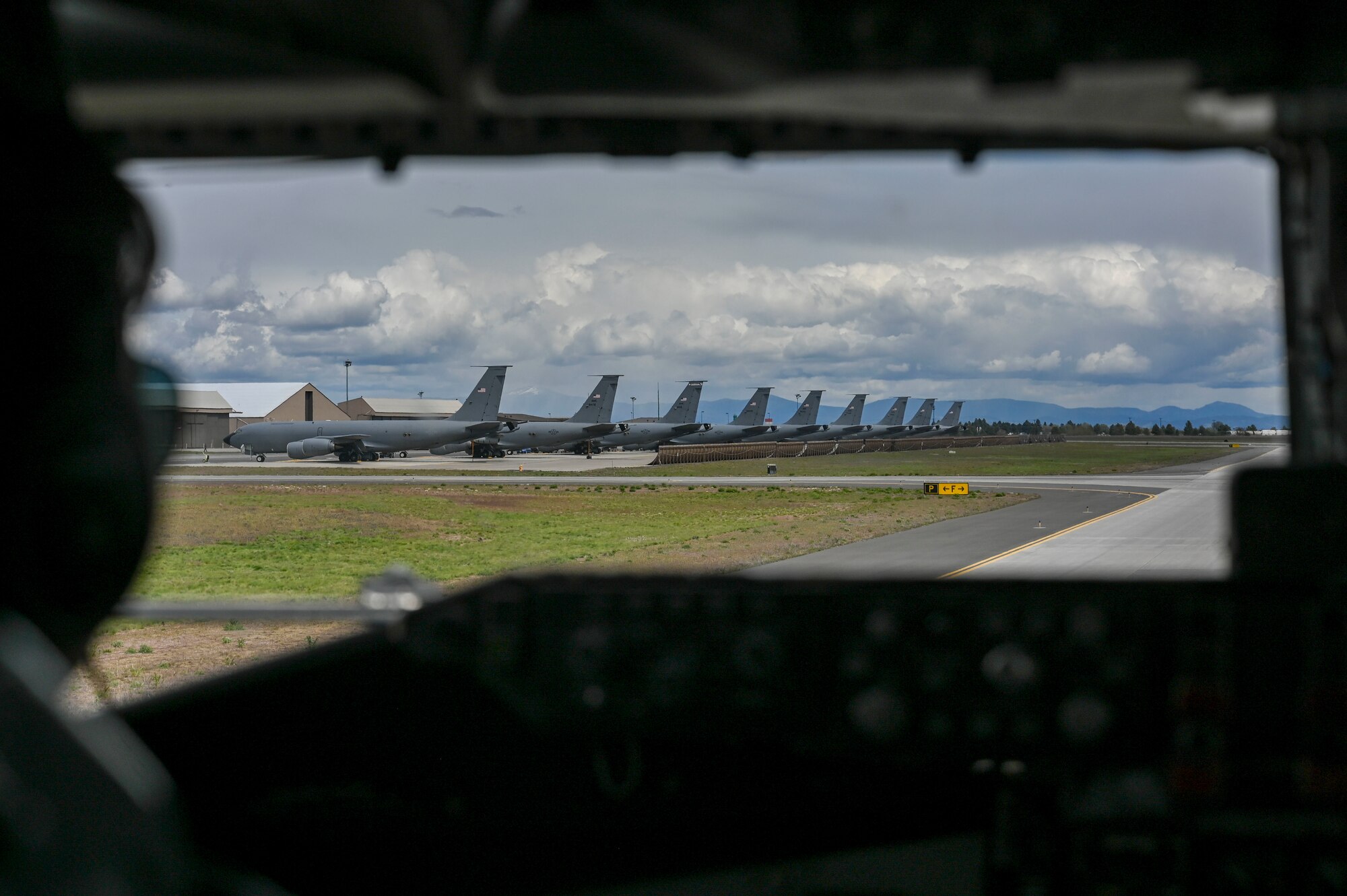 A servicemember taxis a plane on the runway
