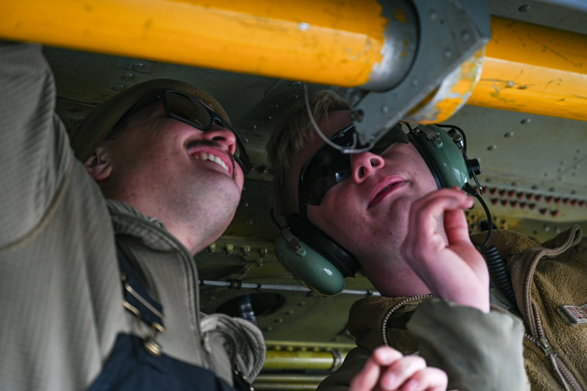 Servicemembers work on a plane
