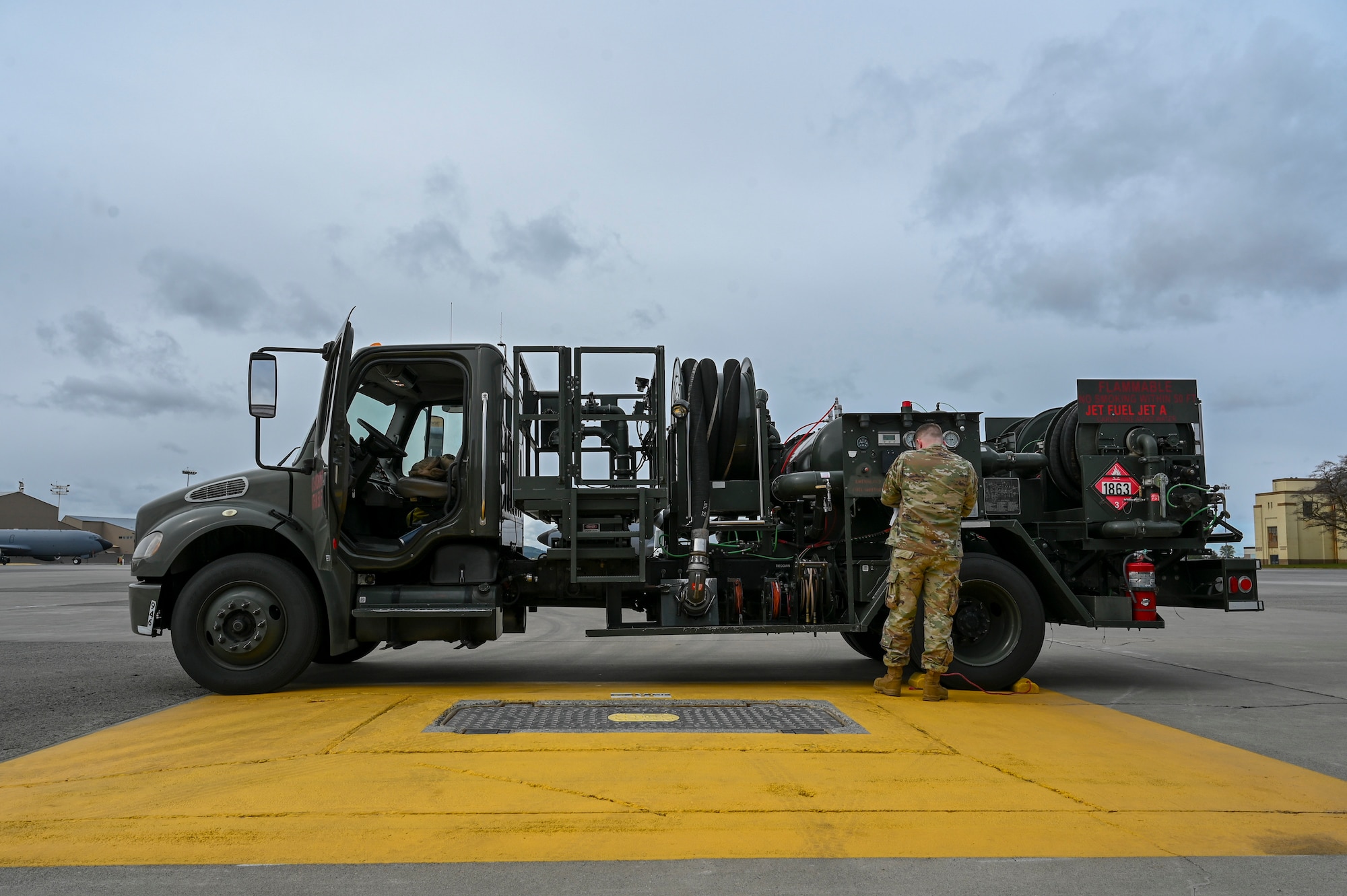 A servicemember inspects a fuel truck