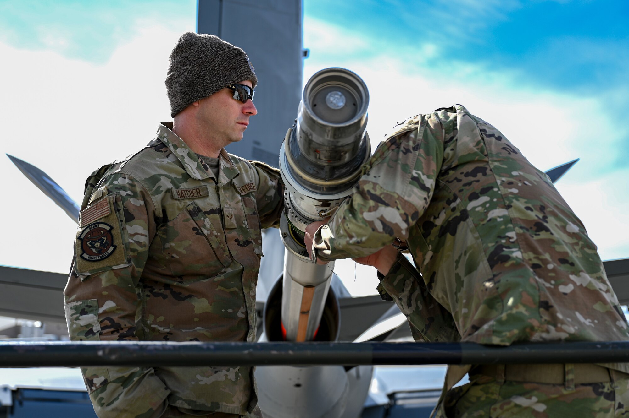 Servicemembers work on a plane