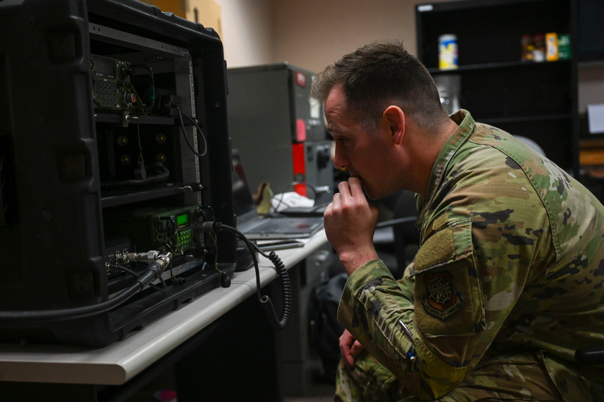A servicemember checks a radio