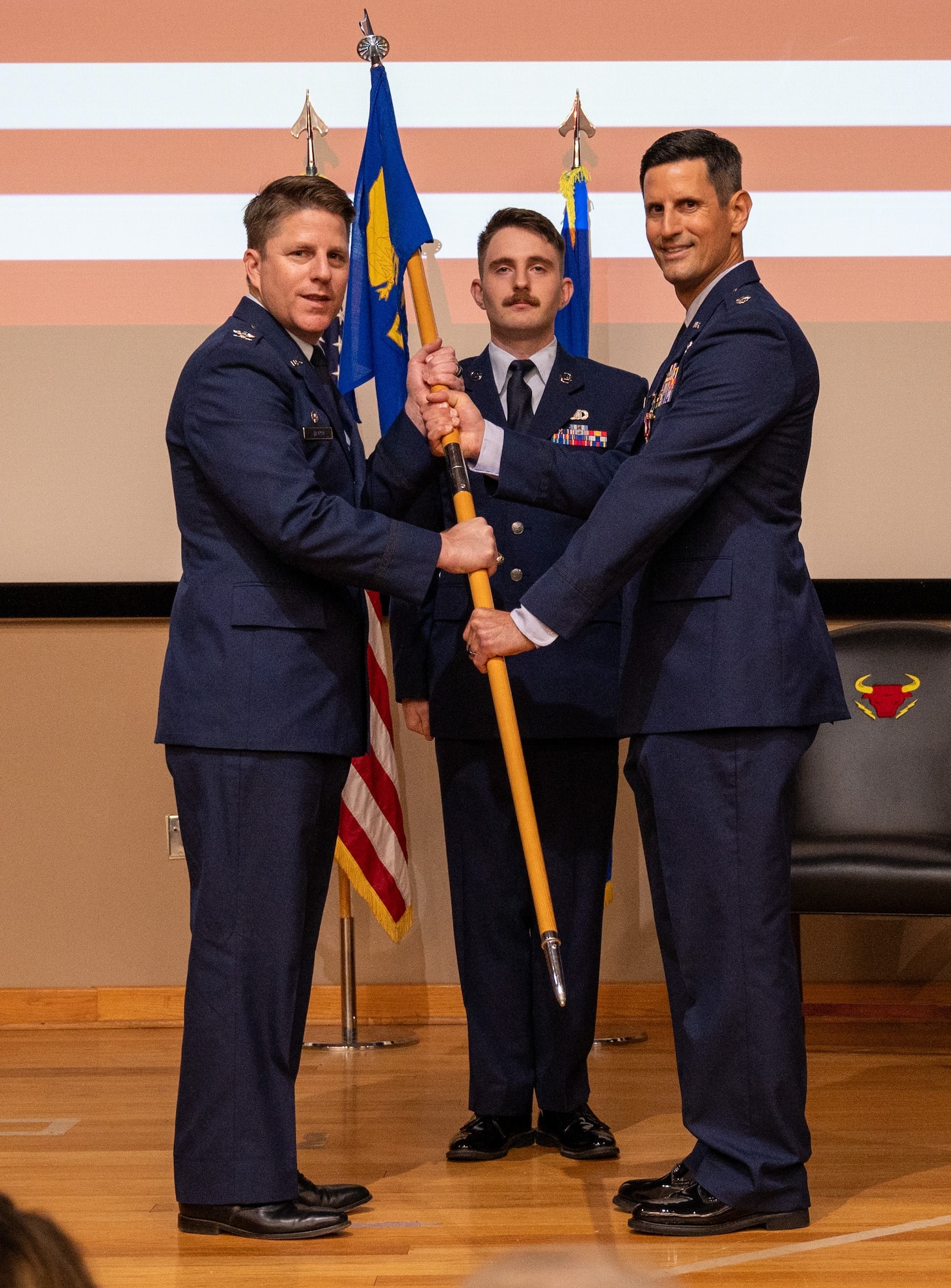 U.S. Air Force Col. James Blech, 47th Operations Group commander, accepts the guidon from Lt. Col. Christopher Johansson, 87th Flying Training Squadron commander, during the change of command ceremony at Laughlin Air Force Base, Texas, May 9, 2024. Change of command ceremonies represent a formal transfer of authority and responsibility for a unit from one commanding officer to another. (U.S. Air Force photo by Staff Sgt. Nicholas Larsen)