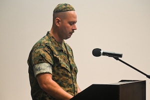 U.S. Marine Corps Sgt. Yaakov Grossman, Marine Corps Detachment Goodfellow Air Force Base Intel Company intelligence systems instructor, says a prayer at the annual Holocaust Memorial at the Powell Event Center, Goodfellow Air Force Base, Texas, May 6, 2024. The 17th Training Wing hosted the annual Holocaust Memorial to honor the victims and survivors of the Holocaust and to ensure that the lessons of the Holocaust will be taught in perpetuity.  (U.S. Air Force photo by Airman James Salellas)