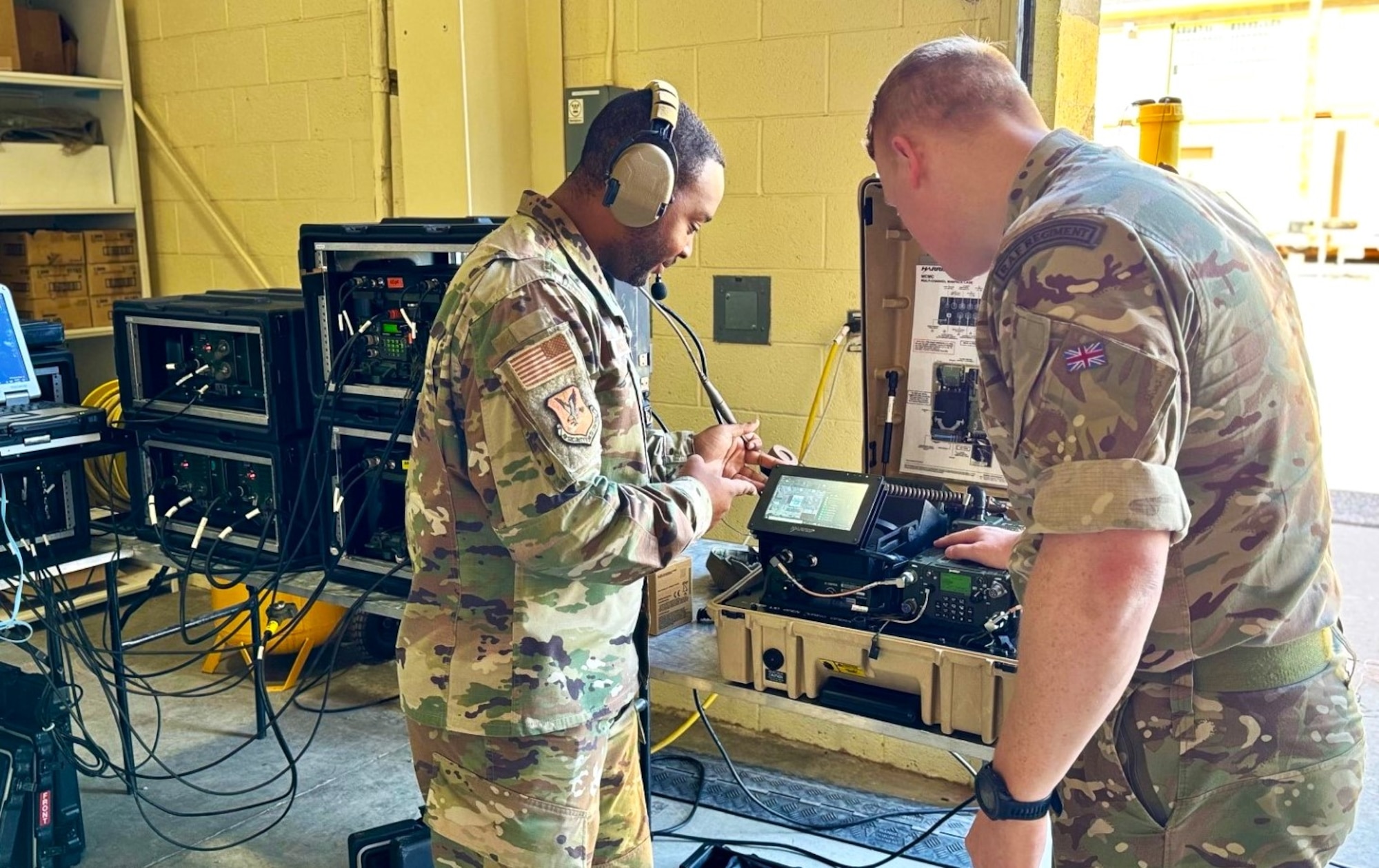 O'Rourke at right looks at equipment while AF member is at his left