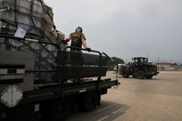 A photo of an Airmen transporting goods.