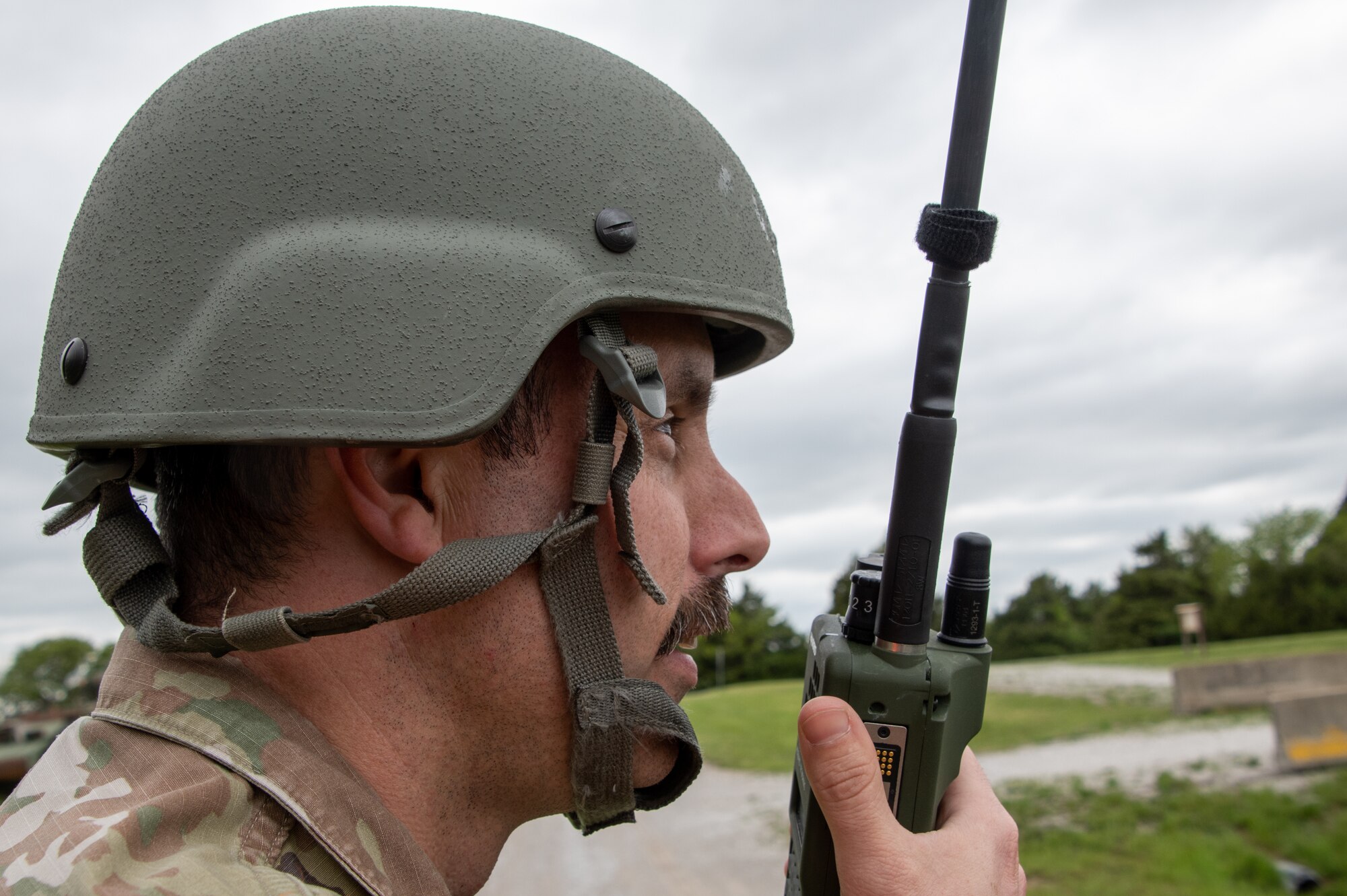 A U.S. Air National Guard Airman communicates using a hand-held radio.
