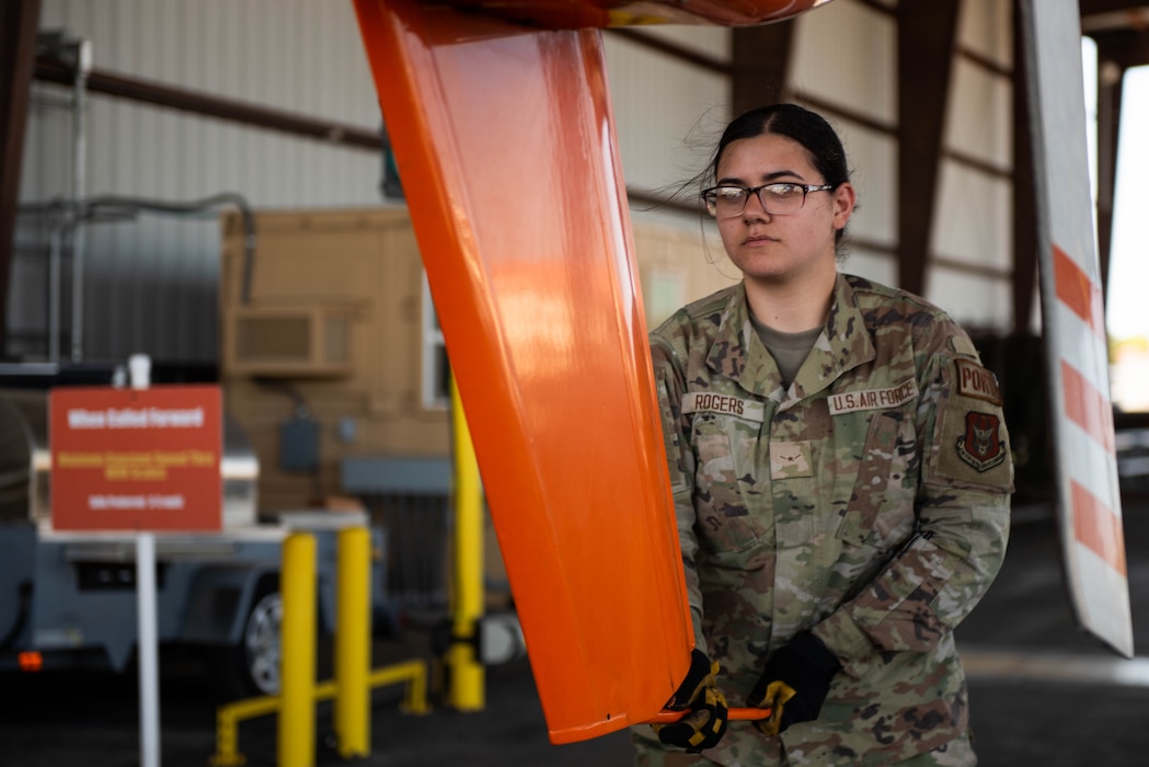 Airman stirs the movement of a helicopter.