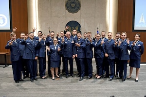 U.S. Air Force Brig. Gen. Jason Rueschhoff (center left), 56th Fighter Wing commander, poses for a group photo at the Air Force Reserve Officer Training Corps Detachment 025’s Commissioning Ceremony May 8, 2024, at Arizona State University, Arizona.
