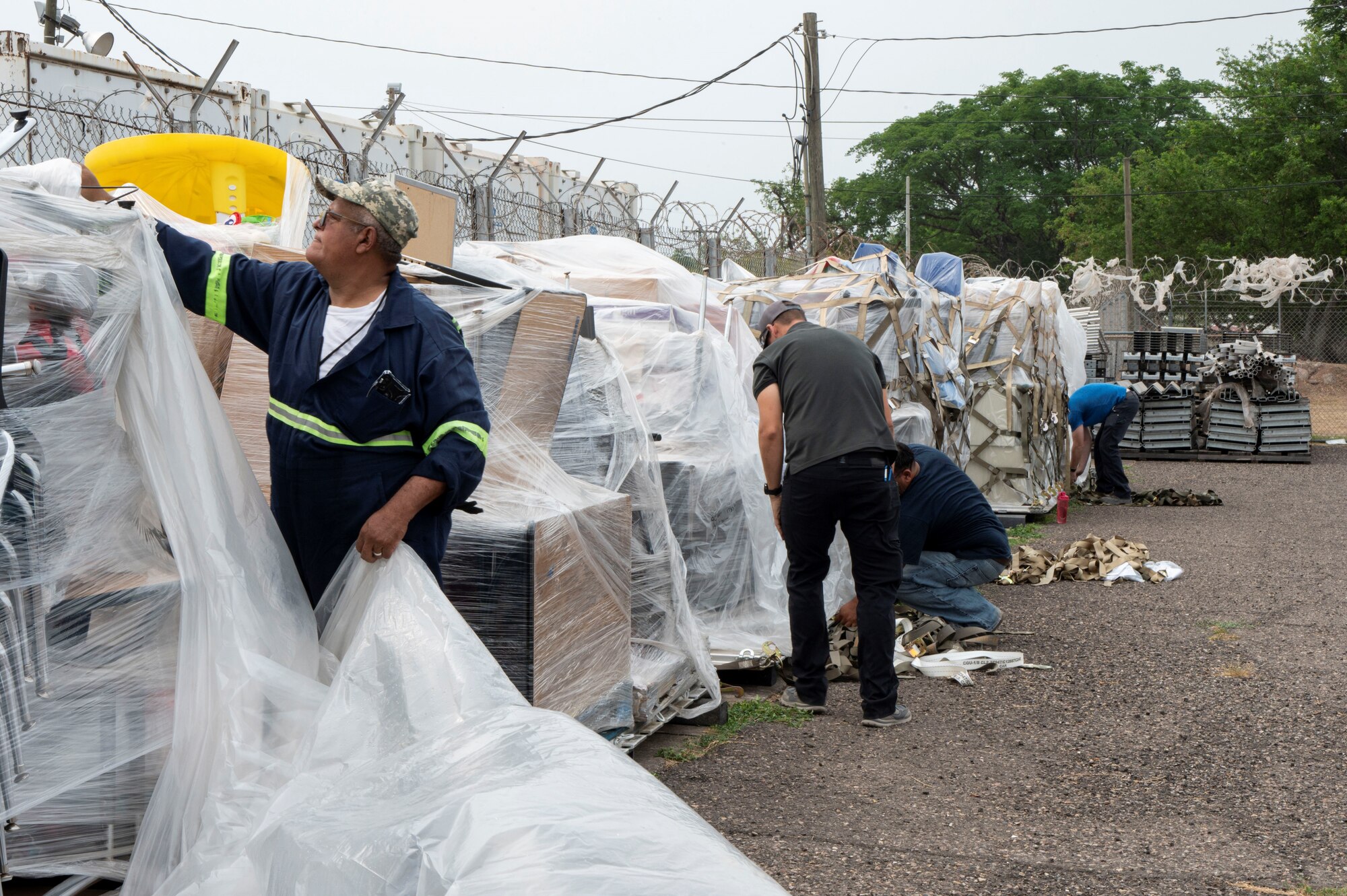 A photo of people pulling plastic off.
