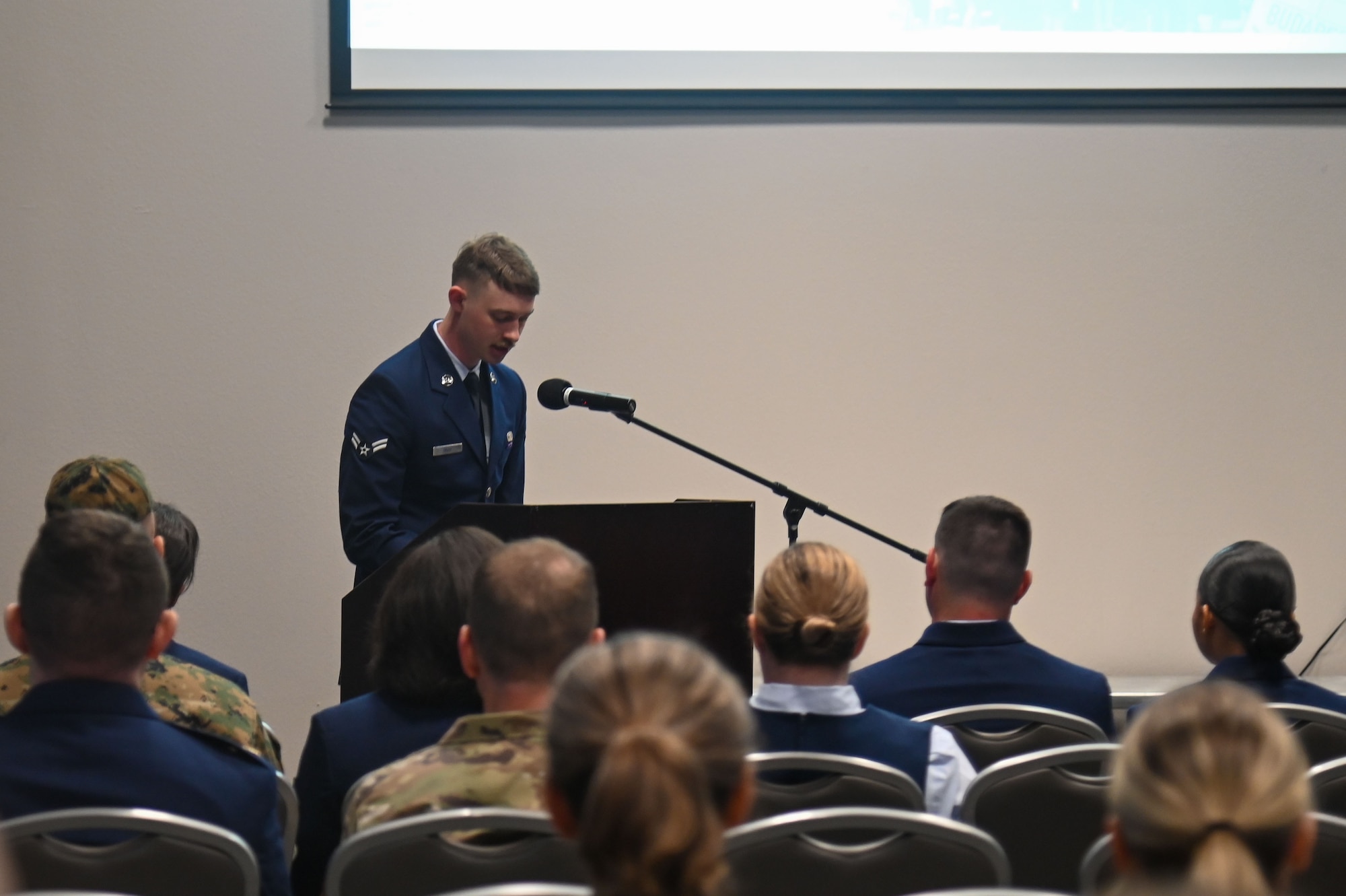 A featured speaker at the annual Holocaust Memorial goes up to the podium and reads the testimonies from victims of the Holocaust at the Powell Event Center, Goodfellow Air Force Base, Texas, May 6, 2024. The memorial was dedicated to remembering the stories of those lost during the Holocaust and those who lived to spread them while informing a new generation about the reality of the atrocities caused by the Holocaust. (U.S. Air Force photo by Airman James Salellas)