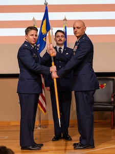 U.S. Air Force Col. James Blech, 47th Operations Group commander, presents the guidon to Lt. Col. Johnathan Radtke, new 87th Flying Training Squadron commander, during the change of command ceremony at Laughlin Air Force Base, Texas, May 9, 2024. Change of command ceremonies represent a formal transfer of authority and responsibility for a unit from one commanding officer to another. (U.S. Air Force photo by Staff Sgt. Nicholas Larsen)