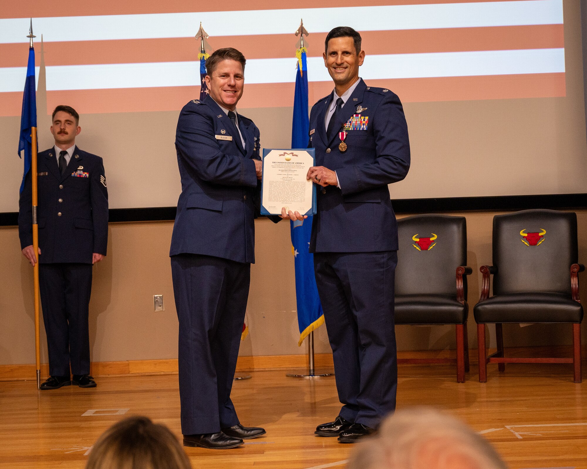 U.S. Air Force Col. James Blech, 47th Operations Group commander, presents the meritorious service medal to Lt. Col. Christopher Johansson, 87th Flying Training Squadron commander, during the change of command ceremony at Laughlin Air Force Base, Texas, May 9, 2024. The Meritorious Service Medal was established as the counterpart of the Bronze Star Medal for the recognition of meritorious noncombatant service. (U.S. Air Force photo by Staff Sgt. Nicholas Larsen)