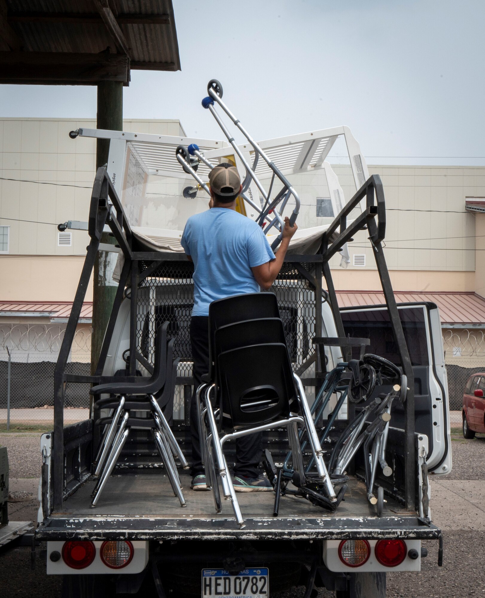 A photo of a man loading a truck.