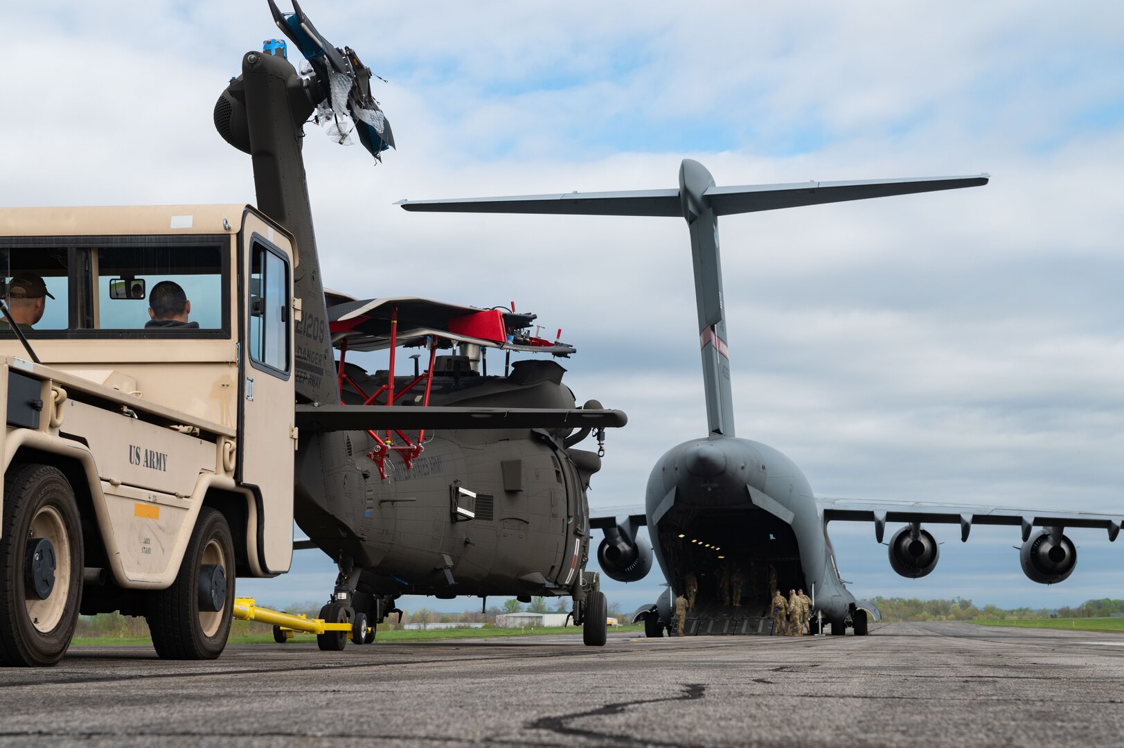 a helicopter and aircraft are parked on a flightline