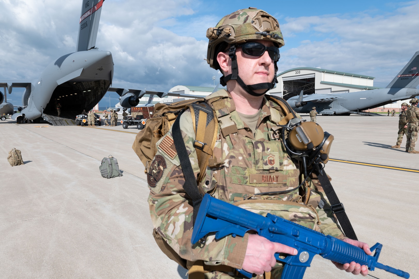 a man stands at the tail end of an aircraft