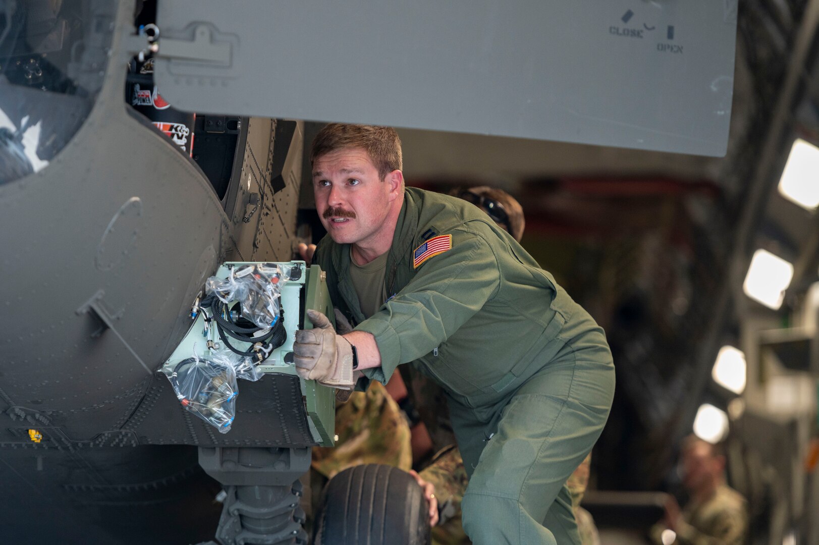 a man pushes on the side of a helicopter