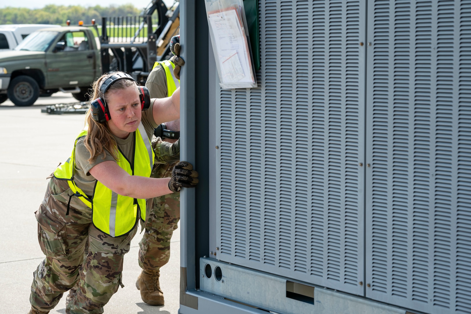 a women pushes a large piece of equipment